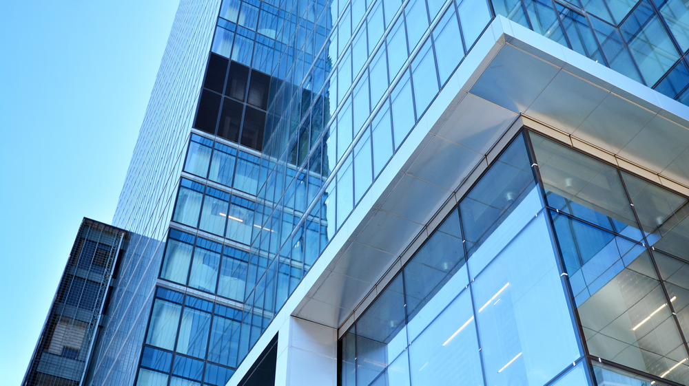 Bottom,View,Of,Modern,Skyscrapers,In,Business,District,Against,Blue